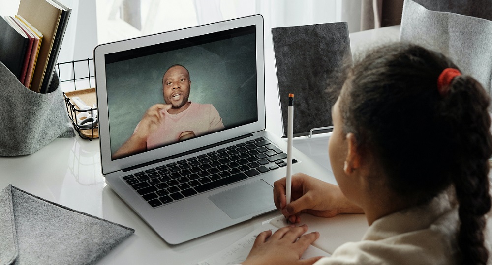 Young person taking Online Classes with adult - photo by August De Richelieu From Pexels - resilient school in crisis